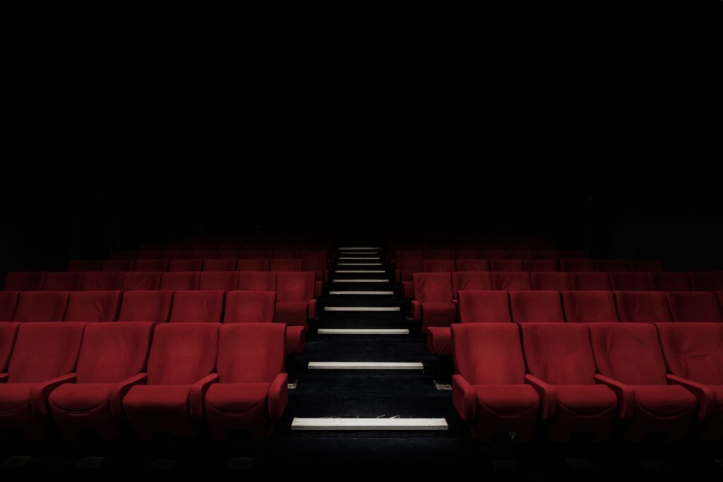 Red chairs in a darkened Theater